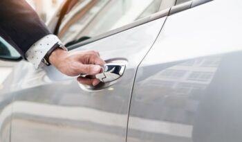 Chauffeur s hand on handle. Close-up of man in formal wear opening a passenger car door.